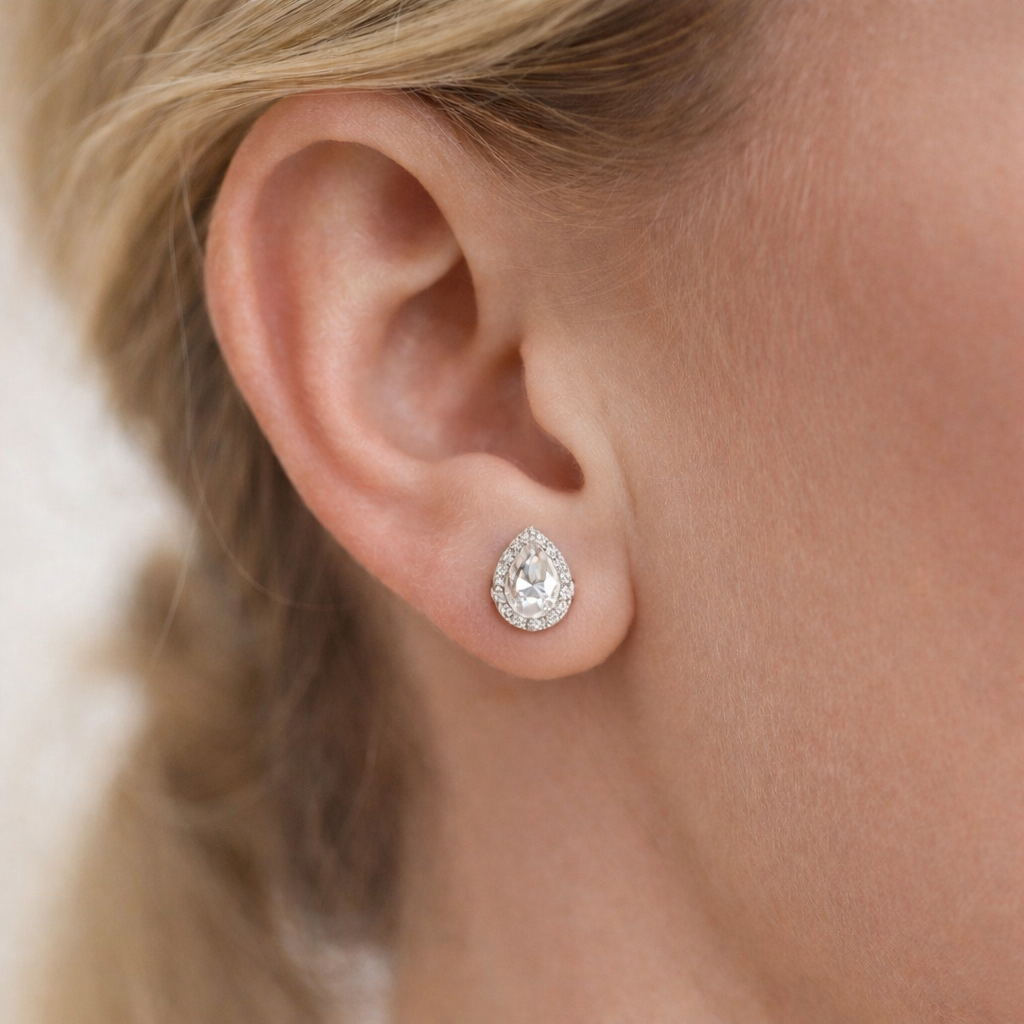 Pear-cut moissanite halo stud earring in a silver-tone setting