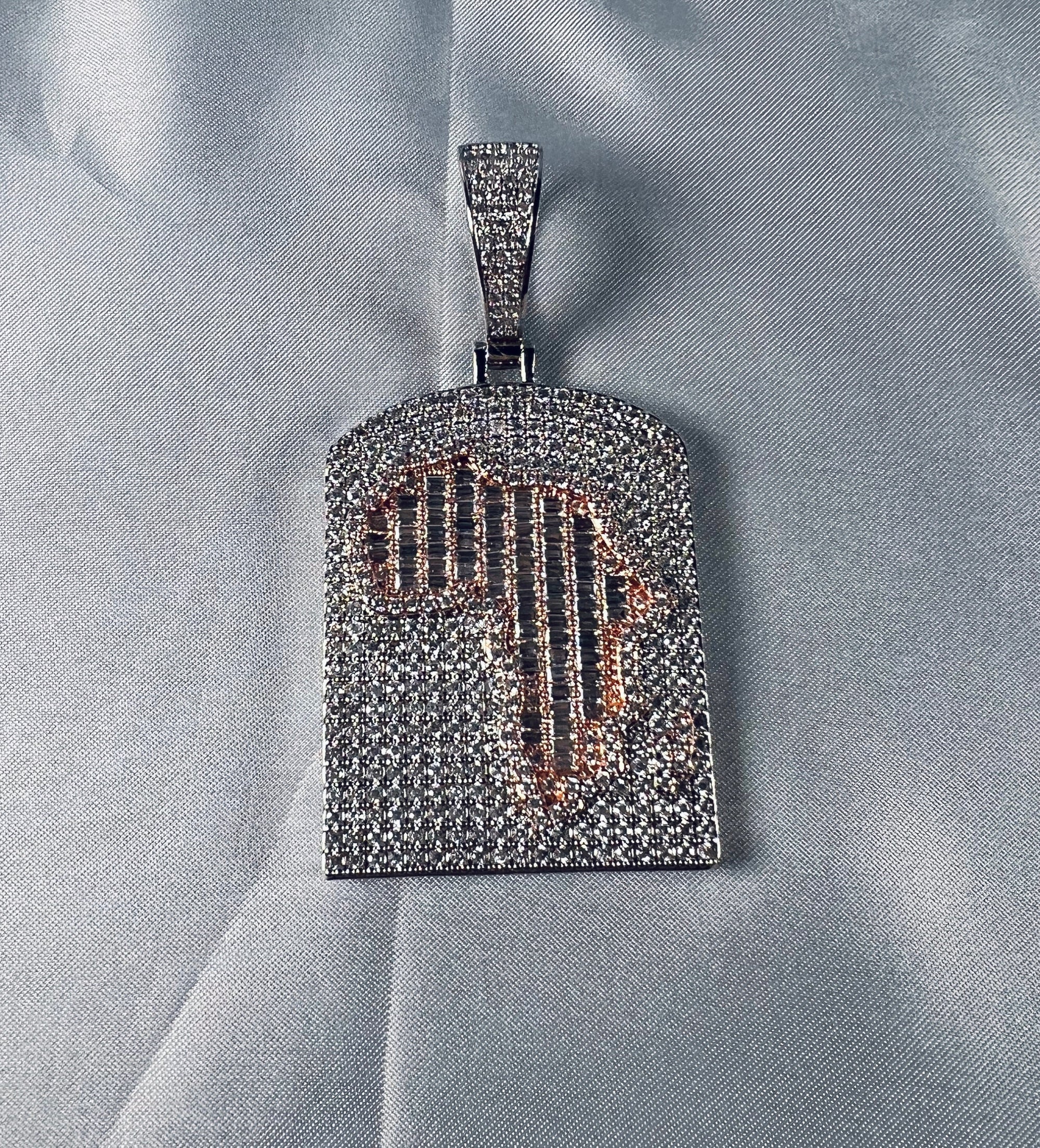 Silver-tone iced Africa map pendant on a white background