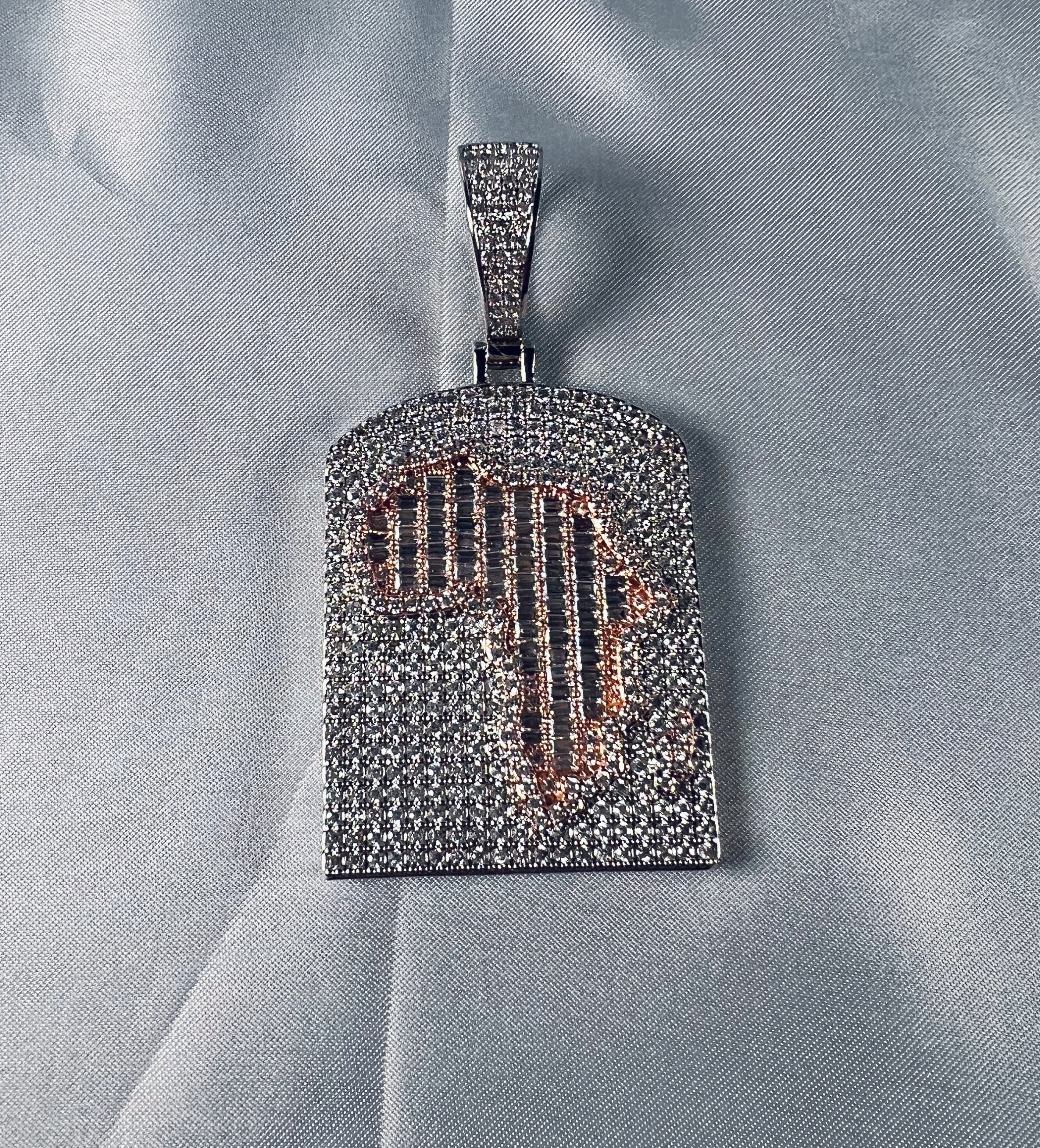 Silver-tone iced Africa map pendant on a white background