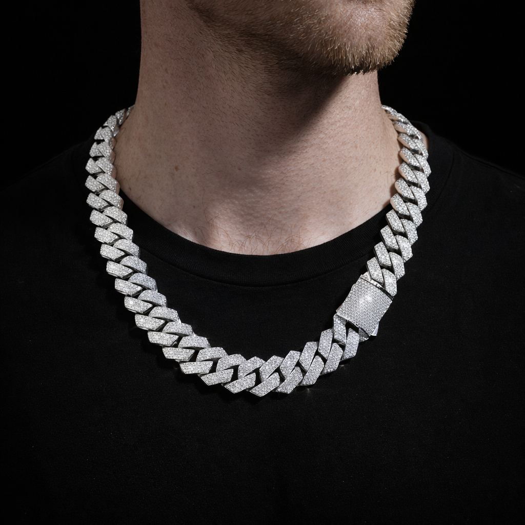 Silver-tone iced Cuban link chain worn over a black shirt