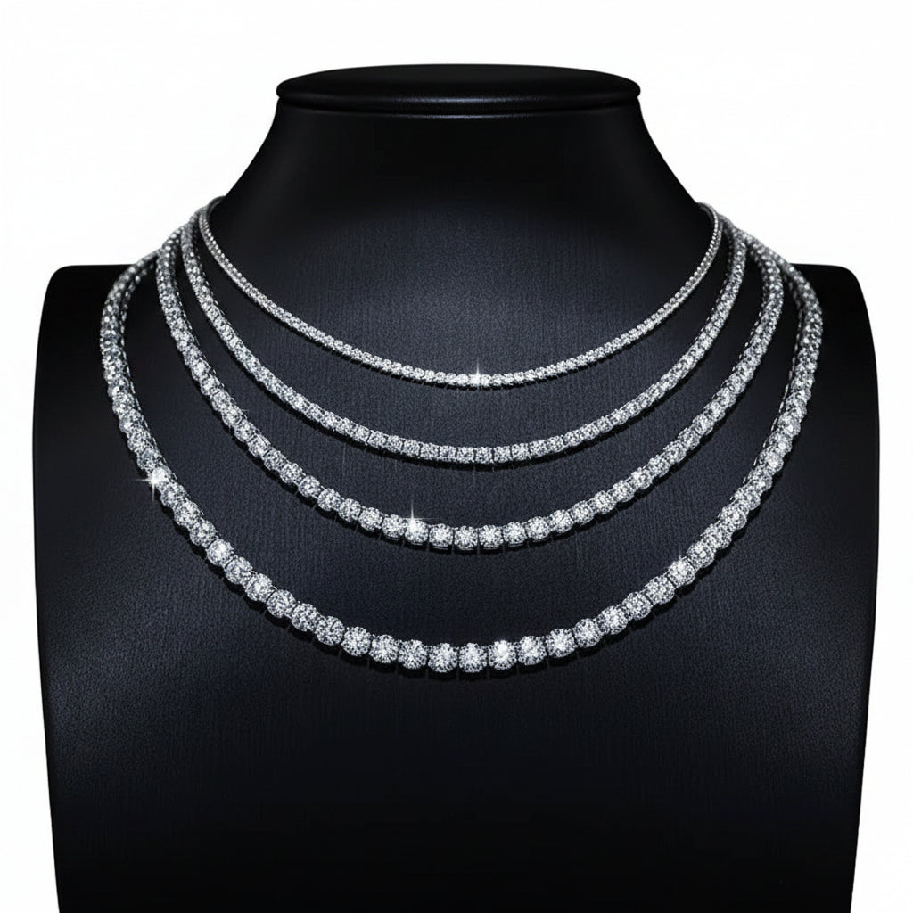 Silver-tone tennis necklaces in several widths on a black display bust