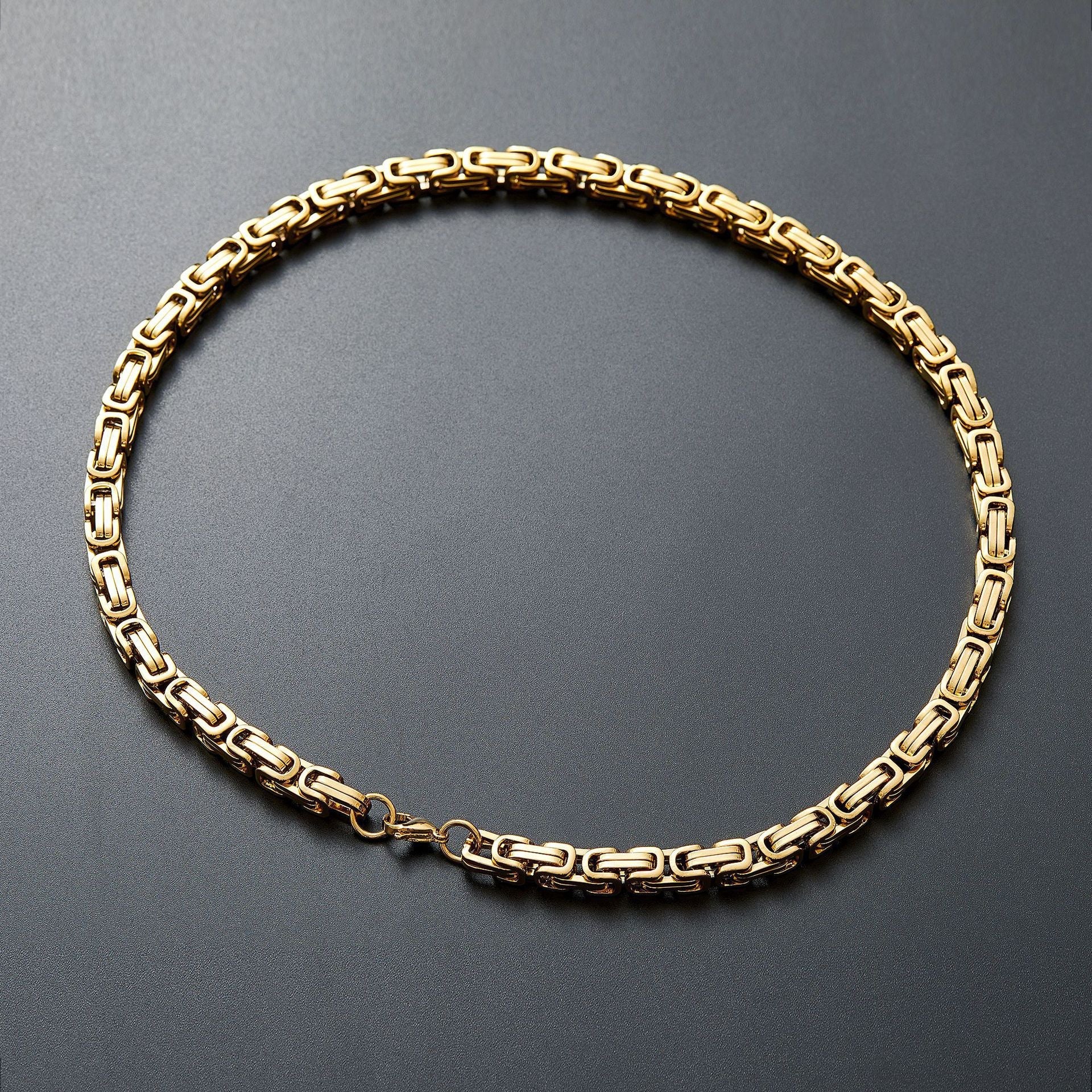 Gold-tone Byzantine chain necklace on a dark background