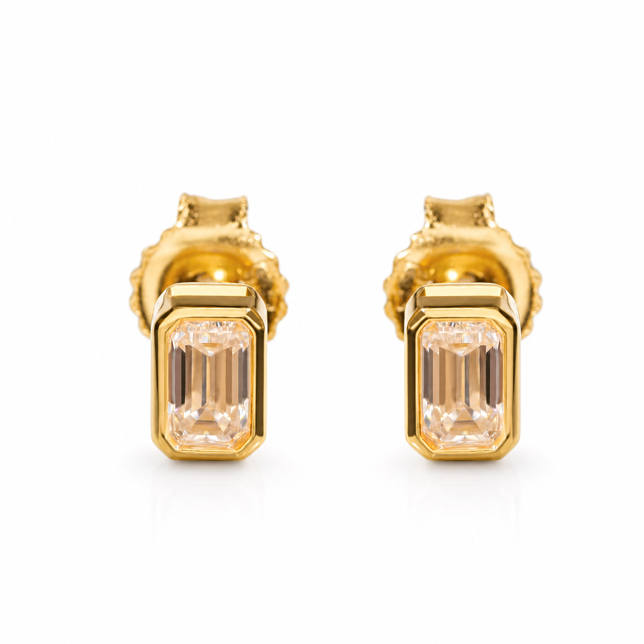 Gold-tone emerald-cut moissanite stud earrings on a white background