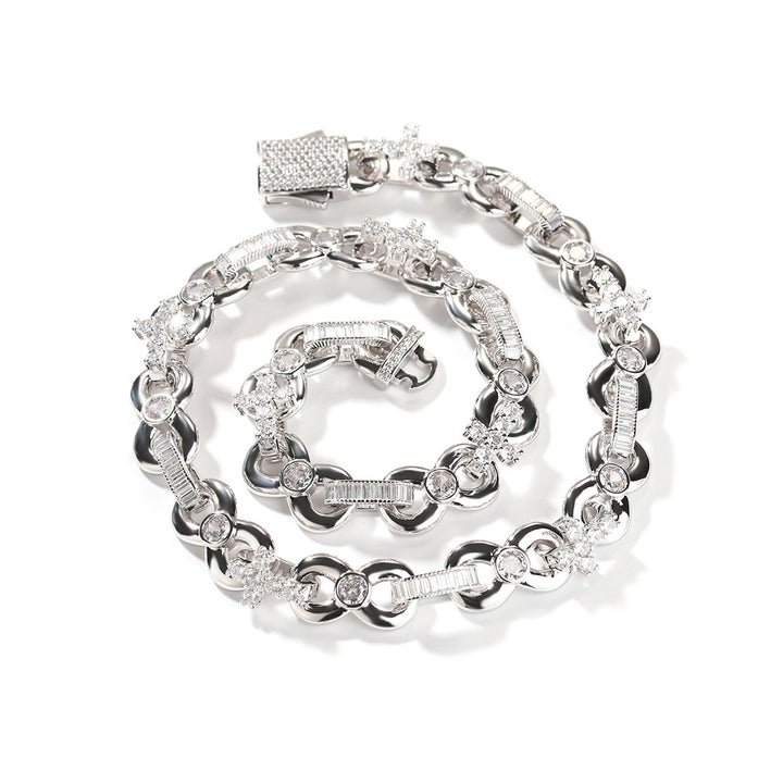 Silver-tone necklace with alternating oval and round links coiled on white