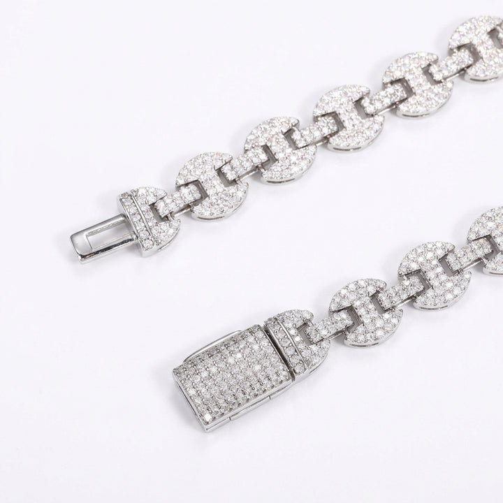 Close-up of moissanite-set mariner links and both parts of the open box clasp