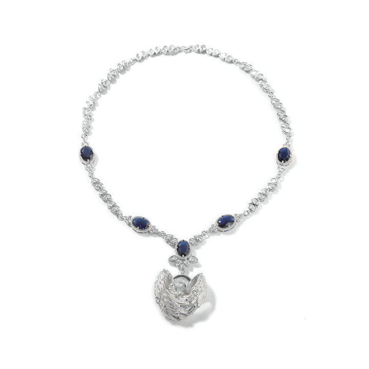 Silver-tone necklace with dark blue stones and an angel-wing centerpiece on white