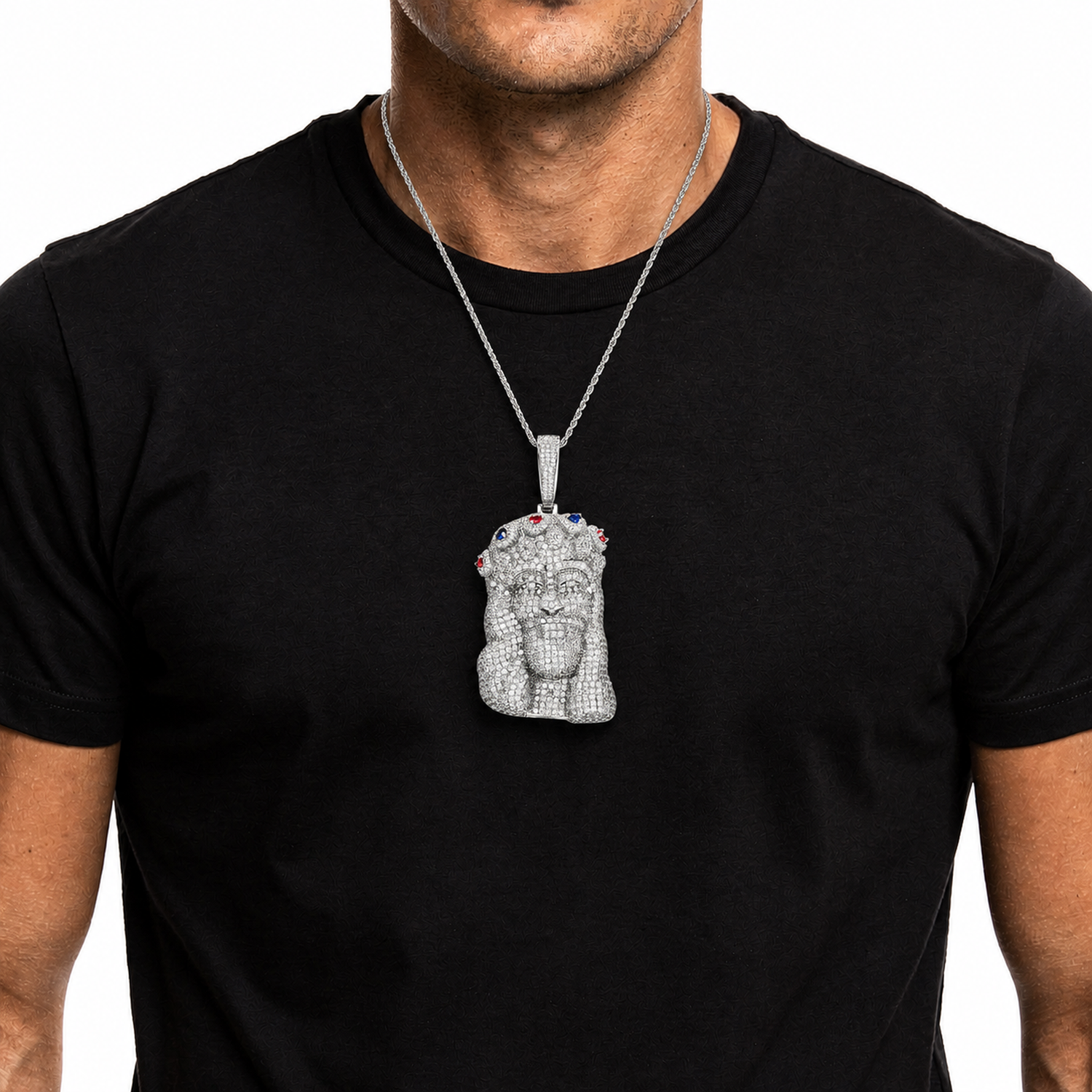 Silver iced out Jesus Piece pendant worn on a black shirt
