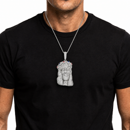 Silver iced out Jesus Piece pendant worn on a black shirt