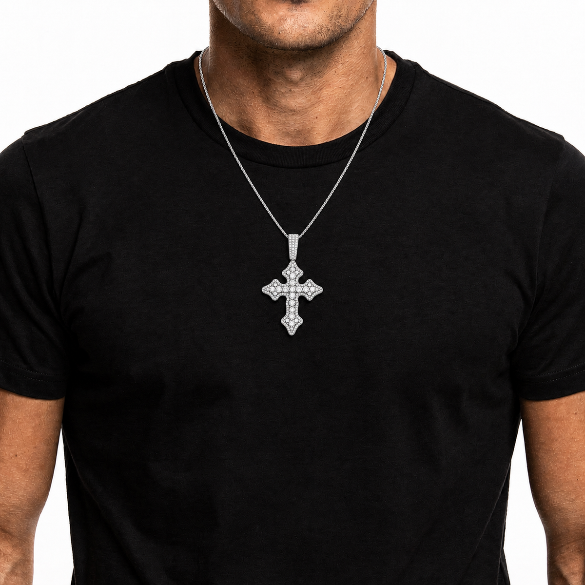 Silver iced vintage cross pendant worn on a black shirt