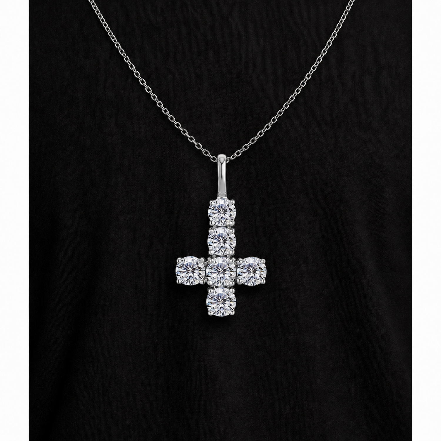Silver iced inverted cross pendant on black fabric