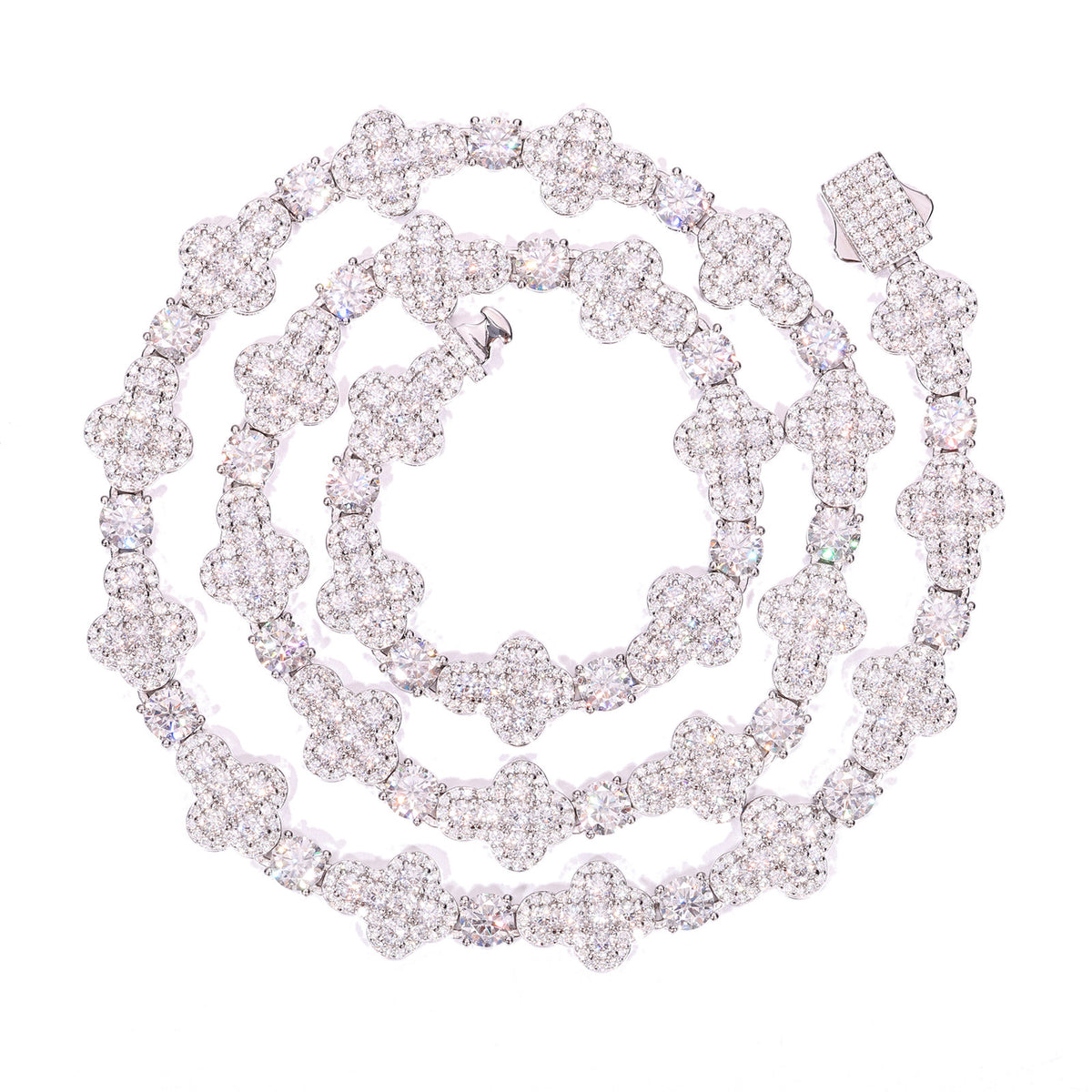 Silver-tone moissanite cross tennis chain coiled on a white background