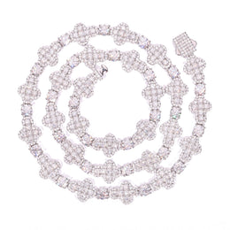 Silver-tone moissanite cross tennis chain coiled on a white background