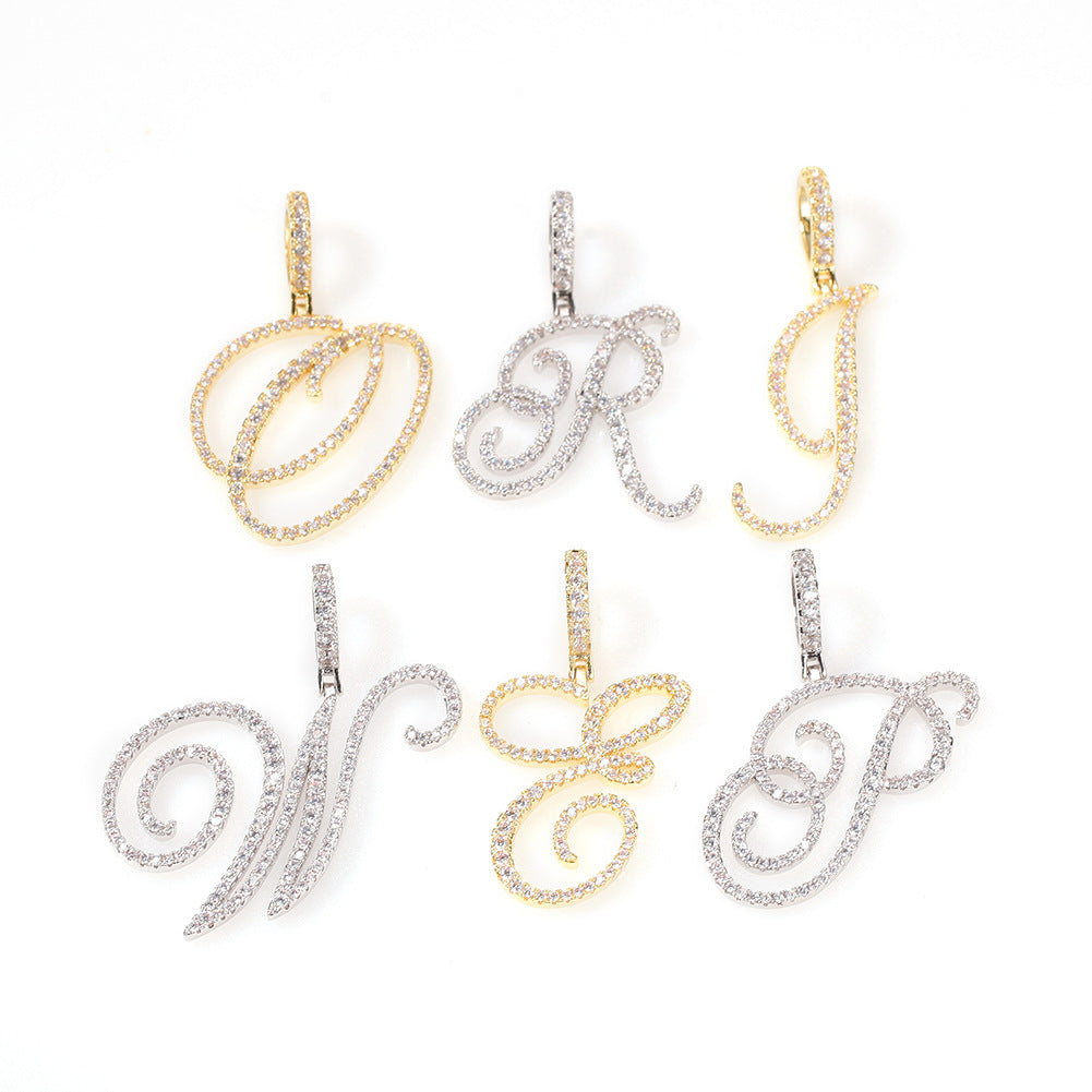 Gold-tone and silver-tone cubic zirconia script letter pendants on white