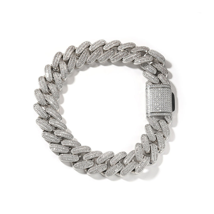Silver-tone wide stone-set Cuban link bracelet arranged on white