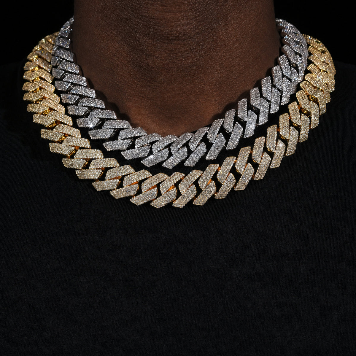 Silver and gold 4-row iced Cuban chains worn by a deep-brown model