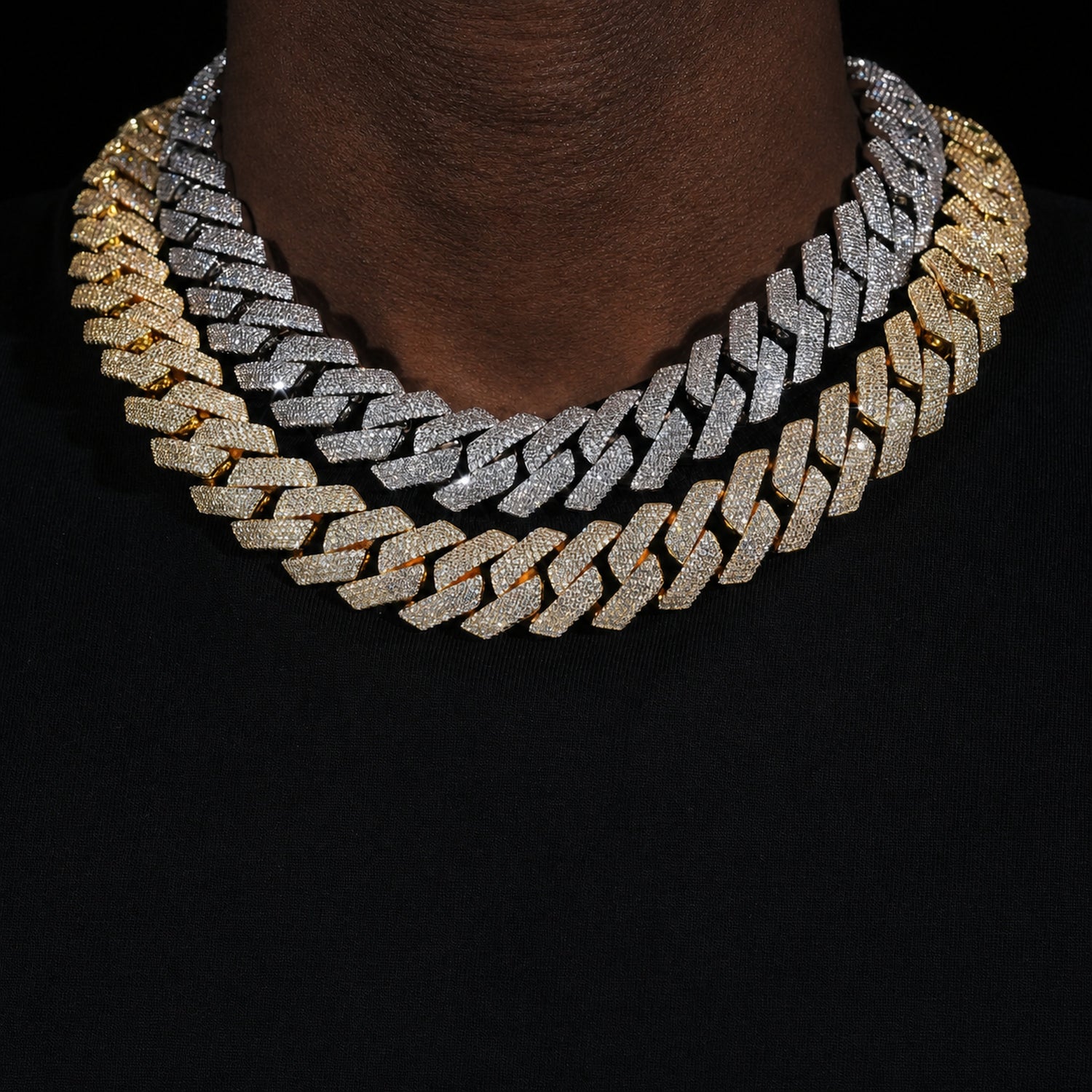 Silver and gold 4-row iced Cuban chains worn by a deep-brown model