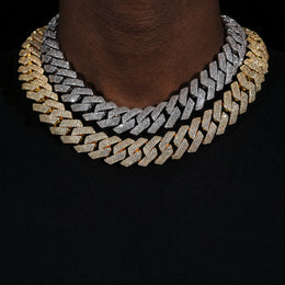 Silver and gold 4-row iced Cuban chains worn by a deep-brown model