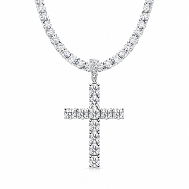 Silver-tone stone-set cross pendant on a tennis chain against white