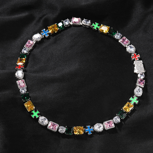 Multicolor cross link necklace arranged in a circle on black fabric