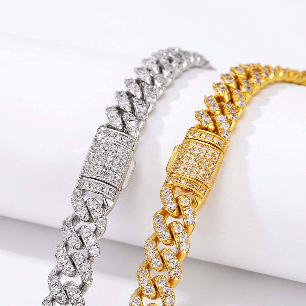 Silver and Gold moissanite Cuban links and stone-set box clasps on white fabric
