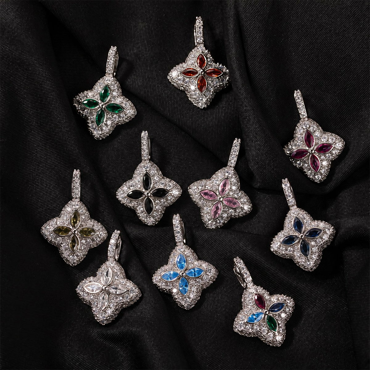 Ten silver-tone colored four-leaf clover pendants arranged on black fabric