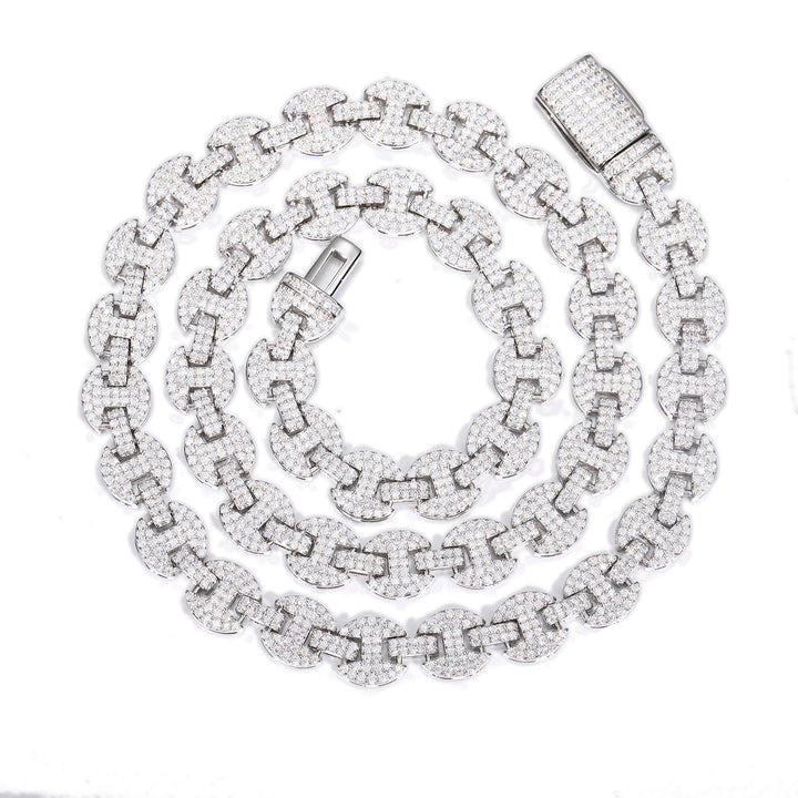 Silver-tone moissanite mariner chain coiled on white with its open box clasp