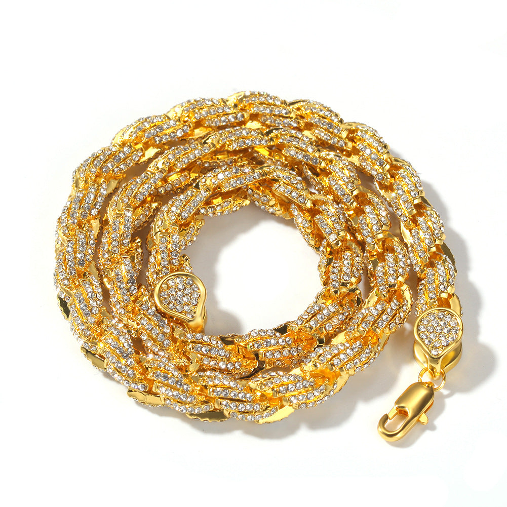 Gold 9mm iced twisted rope chain coiled on a white background