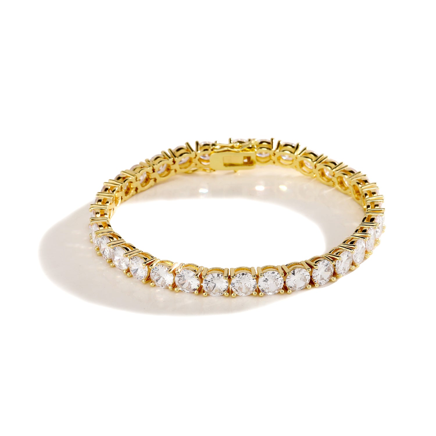 Gold 3–6mm iced cubic zirconia tennis bracelet on white
