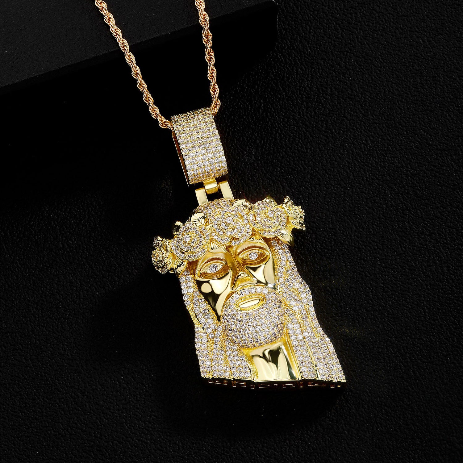 Gold iced Jesus Piece pendant on black background