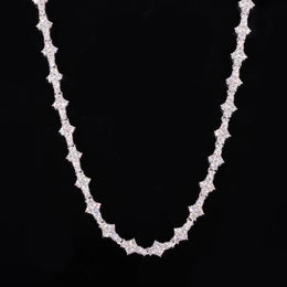 Silver-tone moissanite tennis chain with angular settings draped against black