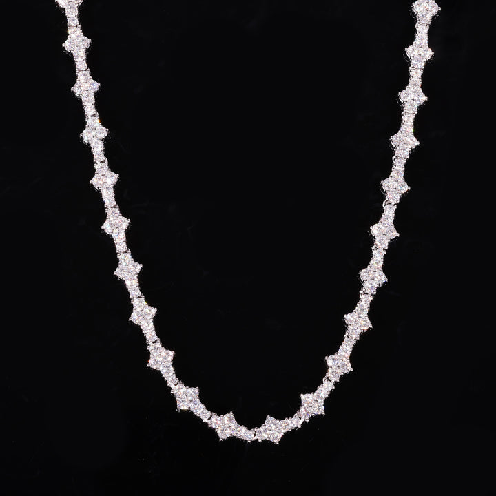 Silver-tone moissanite tennis chain with angular settings draped against black