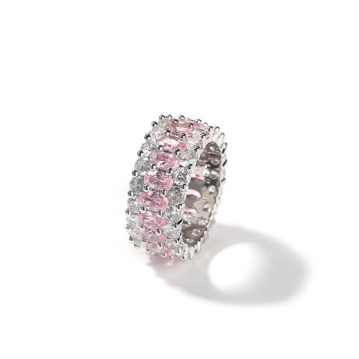 Pink-stone three-row oval ring standing on a white background