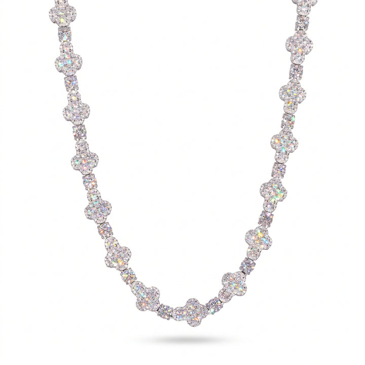 Silver-tone moissanite cross tennis chain draped against a white background