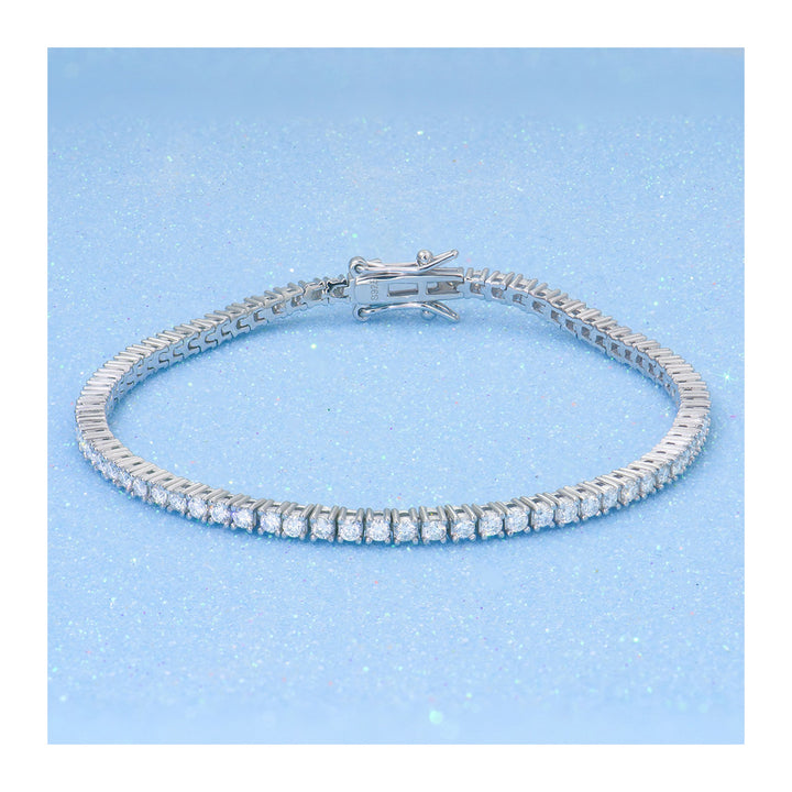 Silver-tone tennis bracelet arranged on pale blue