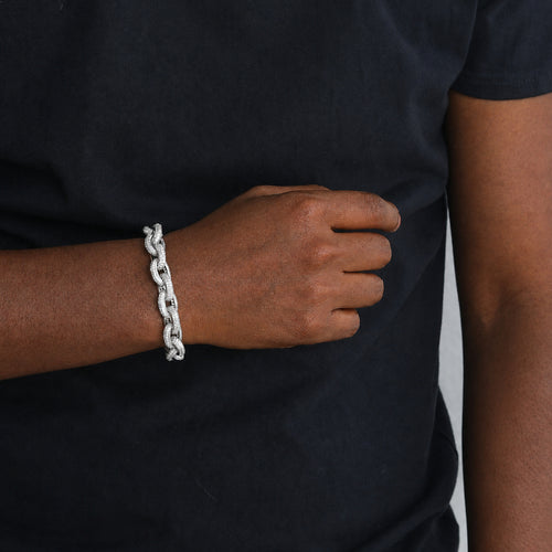 Silver iced O-link bracelet worn by a deep-brown model