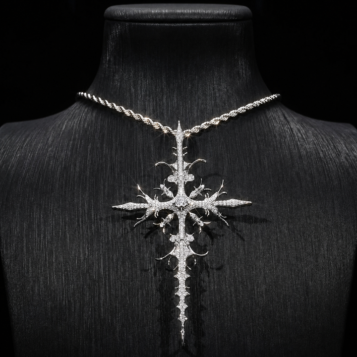 Silver iced thorn cross pendant displayed on black bust