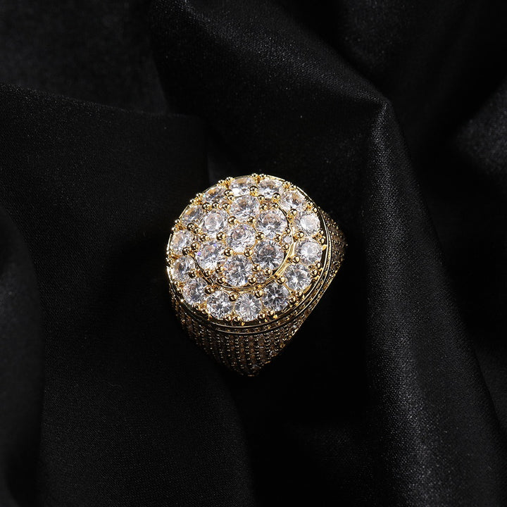 Gold-tone round cluster signet ring on dark fabric