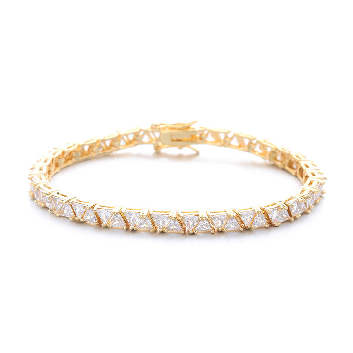 Gold-tone triangle tennis bracelet with its clasp visible on white