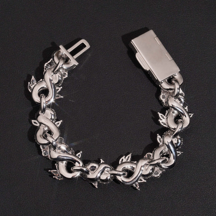 Backs of silver-tone flower links and an open bracelet clasp