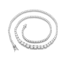 Silver-tone graduated tennis necklace coiled on white with its clasp open