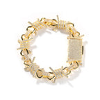 Gold iced barbed wire chain bracelet on white background