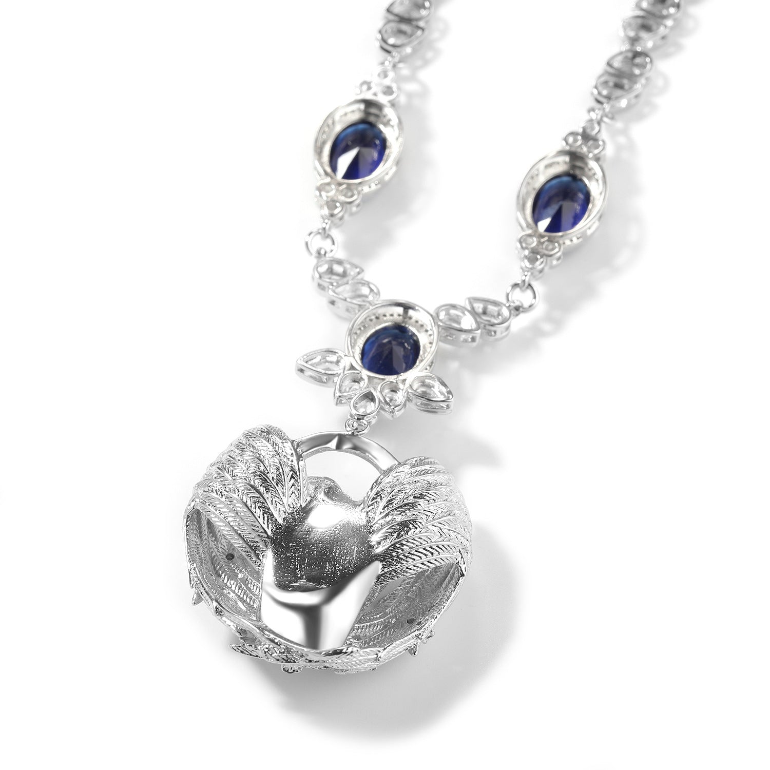 Close-up of the non-detachable angel-wing Cupid necklace and sapphire-blue CZ stones