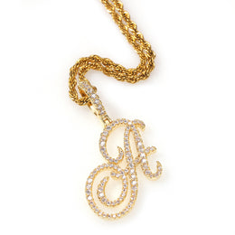 Gold-tone cubic zirconia script letter A pendant on white