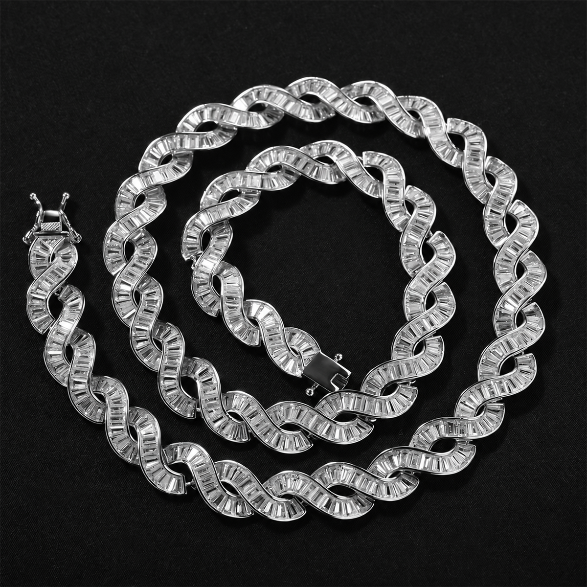 Silver-tone DNA spiral necklace arranged on black fabric with its clasp open
