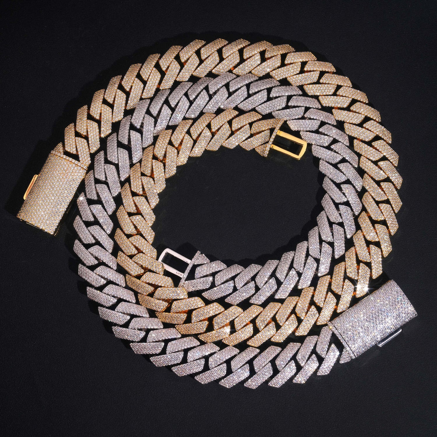 Silver and gold 4-row iced Cuban chains coiled on black