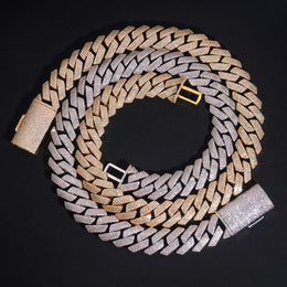 Silver and gold 4-row iced Cuban chains coiled on black