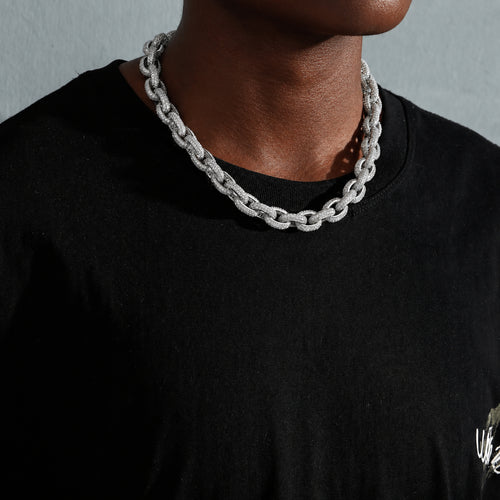 Silver iced O-link chain on a deep-brown model from an angled view