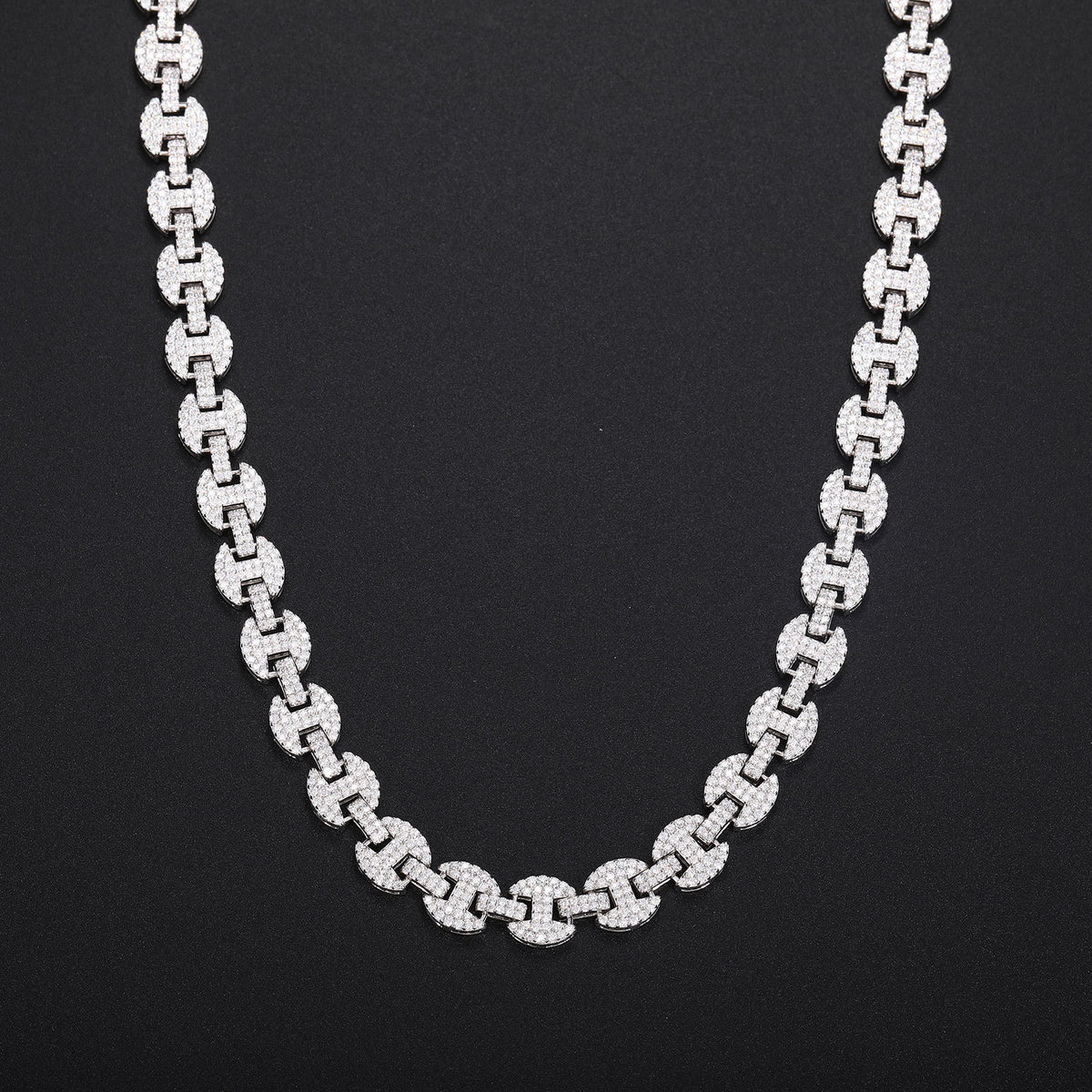 Silver-tone moissanite mariner chain hanging in a U shape against black fabric