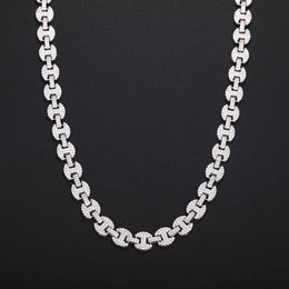 Silver-tone moissanite mariner chain hanging in a U shape against black fabric