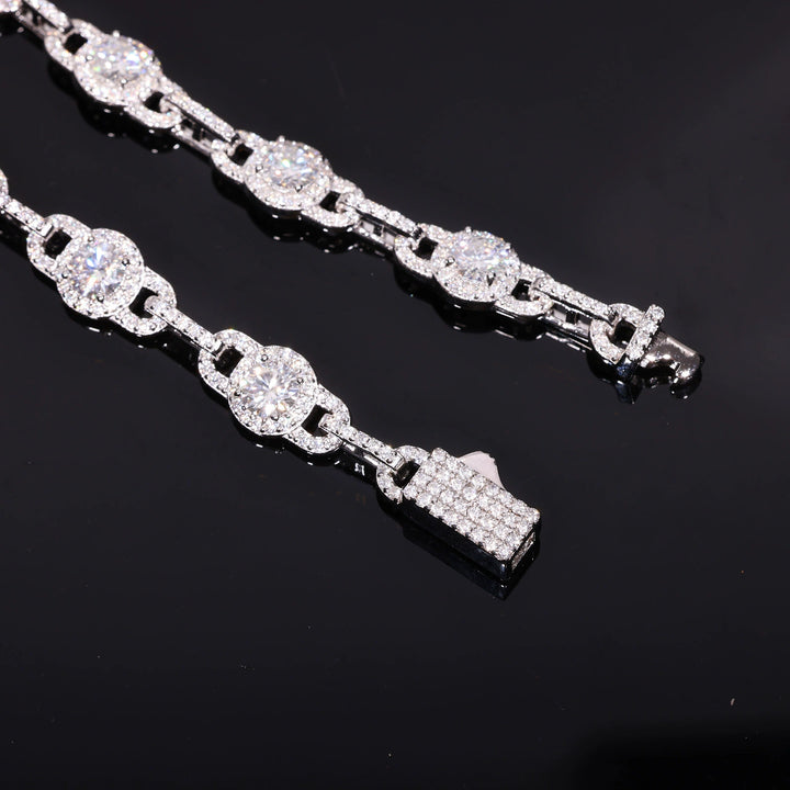 Close-up of round moissanite halo links, narrow connectors and stone-set box clasp